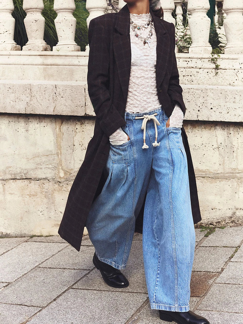FJØRNA women's cotton wide-leg jeans with drawstring waist, shown hanging or styled on a model in a casual setting.