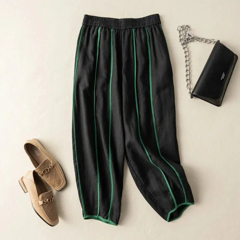 FJØRNA women's linen wide-leg trousers with elastic waist, featuring a relaxed fit and natural fabric for stylish comfort.