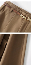 Women’s wool wide-leg trousers by FJØRNA featuring high waist and relaxed fit, shown in a natural fabric texture.