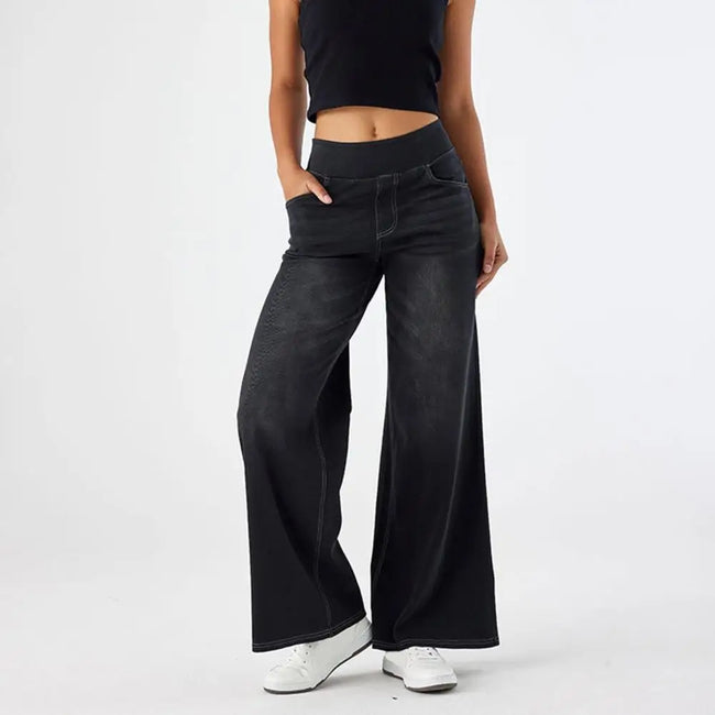 Women’s wide-leg lace jeans by FJØRNA featuring high waist and stylish design, shown in the product image.