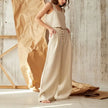 FJØRNA women's knit wide-leg trousers with elastic waistband, showcasing the relaxed fit and soft fabric in a natural pose.