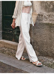 FJØRNA women's knit wide-leg trousers with drawstring waist, soft fabric, and relaxed fit, styled for casual wear.