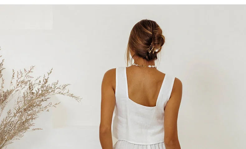 FJØRNA linen wide-leg trousers for women, loose pull-on pants in a relaxed fit, shown in a neutral color on a model.