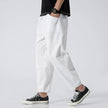 Men's cropped linen trousers in indigo by FJØRNA, featuring a relaxed fit and lightweight fabric for a casual, stylish look.