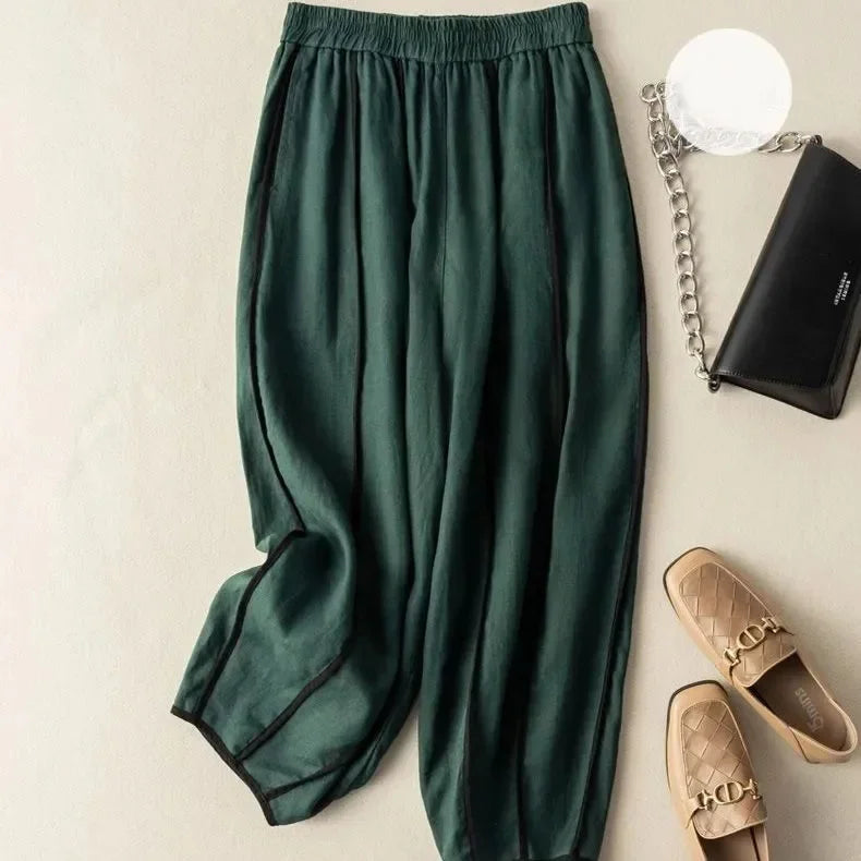 FJØRNA women's linen wide-leg trousers with elastic waist, stylish and comfortable pants for women, shown in natural fabric and relaxed fit.