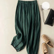 Women's linen wide-leg trousers with elastic waist from FJØRNA, shown in a relaxed fit with natural fabric texture.