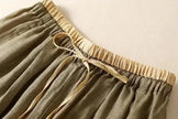 FJØRNA women's linen tapered trousers with a relaxed fit, lightweight fabric, and classic design for casual and stylish wear.