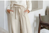 FJØRNA linen wide-leg pull-on trousers for women, showing the loose-fit, high-waisted design and lightweight fabric.