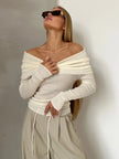 FJØRNA ribbed knit off-shoulder top for women with a mock neck, featuring a fitted design and soft fabric in a natural pose