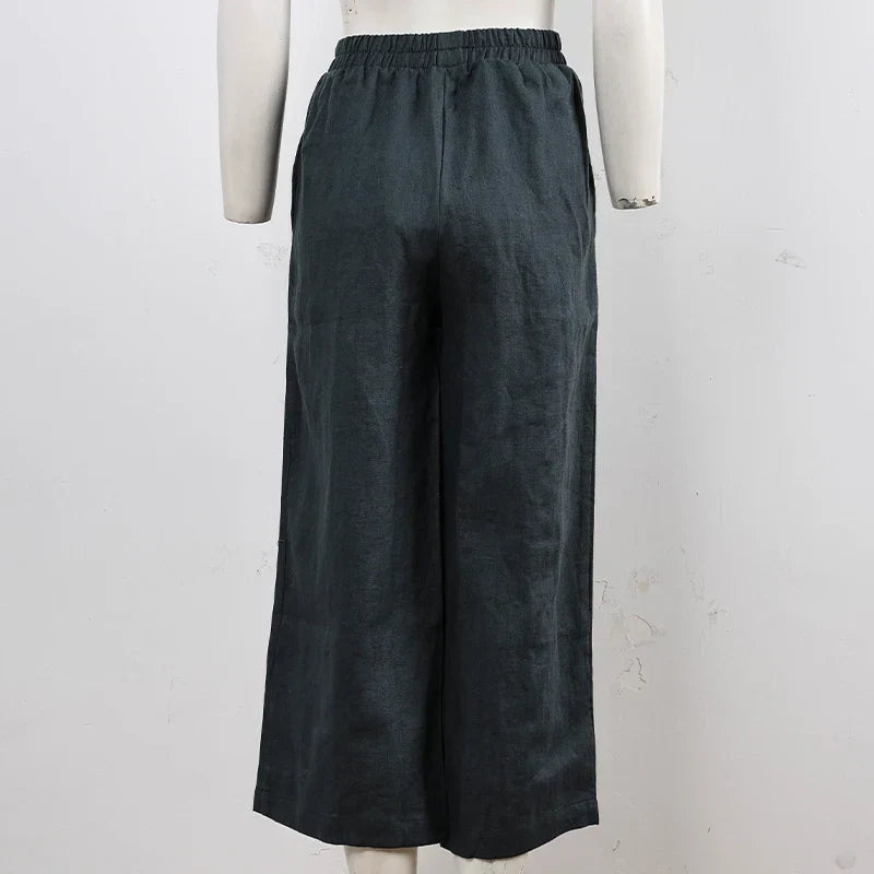 FJØRNA linen wide-leg women's trousers with drawstring pull-on design, featuring a relaxed fit and lightweight fabric.