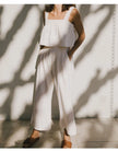 FJØRNA women's linen cropped culotte trousers with wide-leg design, lightweight and breathable fabric, styled for casual wear.