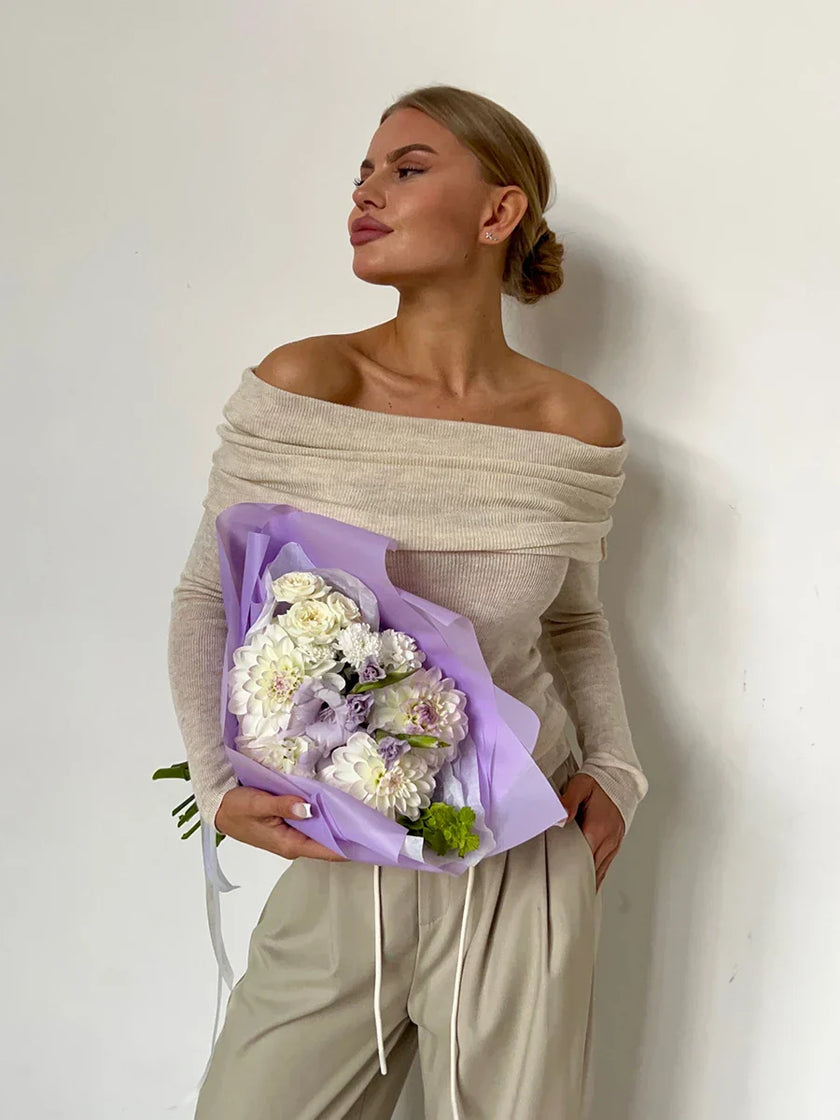 FJØRNA ribbed knit off-shoulder women's top with mock neck, featuring a fitted design and textured fabric.