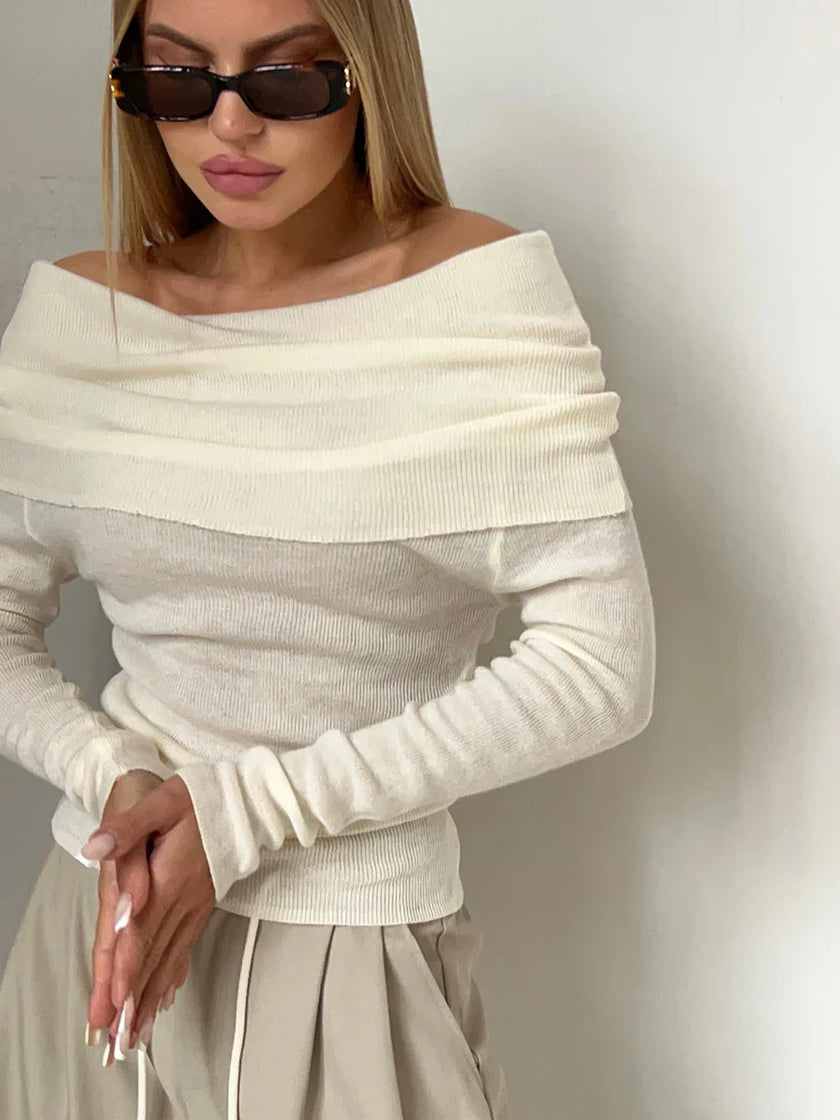 FJØRNA ribbed knit off-shoulder top for women with a mock neck, showcasing the fitted, textured fabric and stylish neckline.