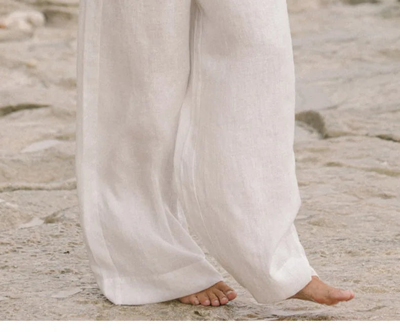 FJØRNA linen wide-leg trousers for women, loose pull-on pants with relaxed fit and natural linen fabric, shown in a neutral color.