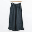 FJØRNA women's linen wide-leg trousers with drawstring pull-on design, relaxed fit, and lightweight fabric for comfortable wear.