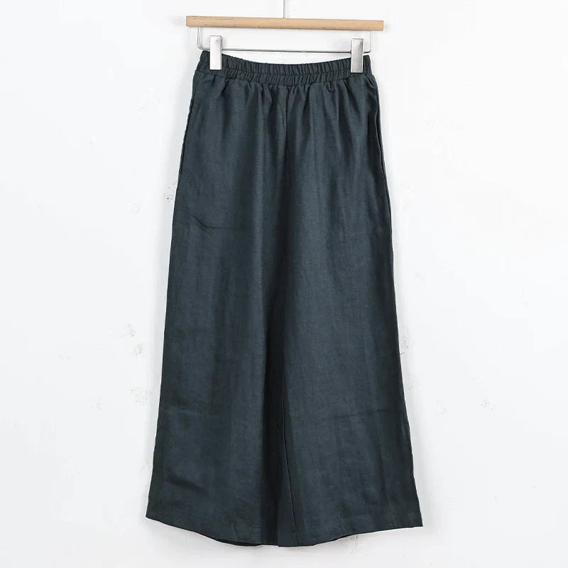 FJØRNA women's linen wide-leg trousers with drawstring pull-on design, relaxed fit, and lightweight fabric for comfortable wear.