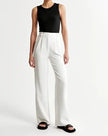 White wide-leg high-waist trousers for women by FJØRNA, showcasing a stylish, flowy fit and high-rise design.