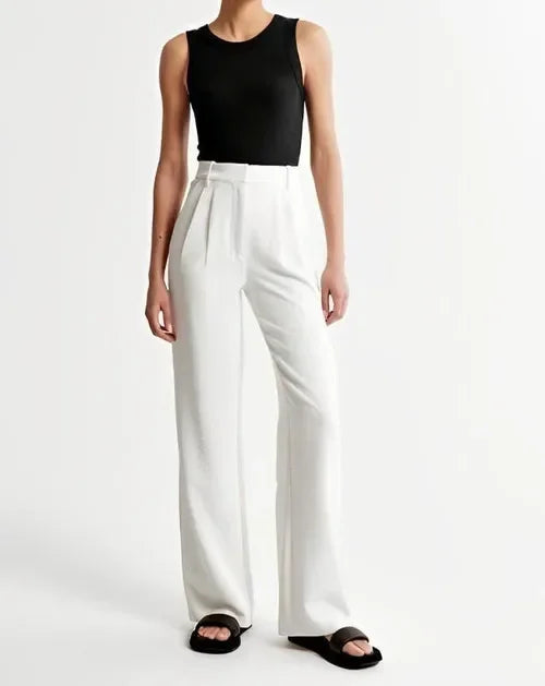 White wide-leg high-waist trousers for women by FJØRNA, showcasing a stylish, flowy fit and high-rise design.