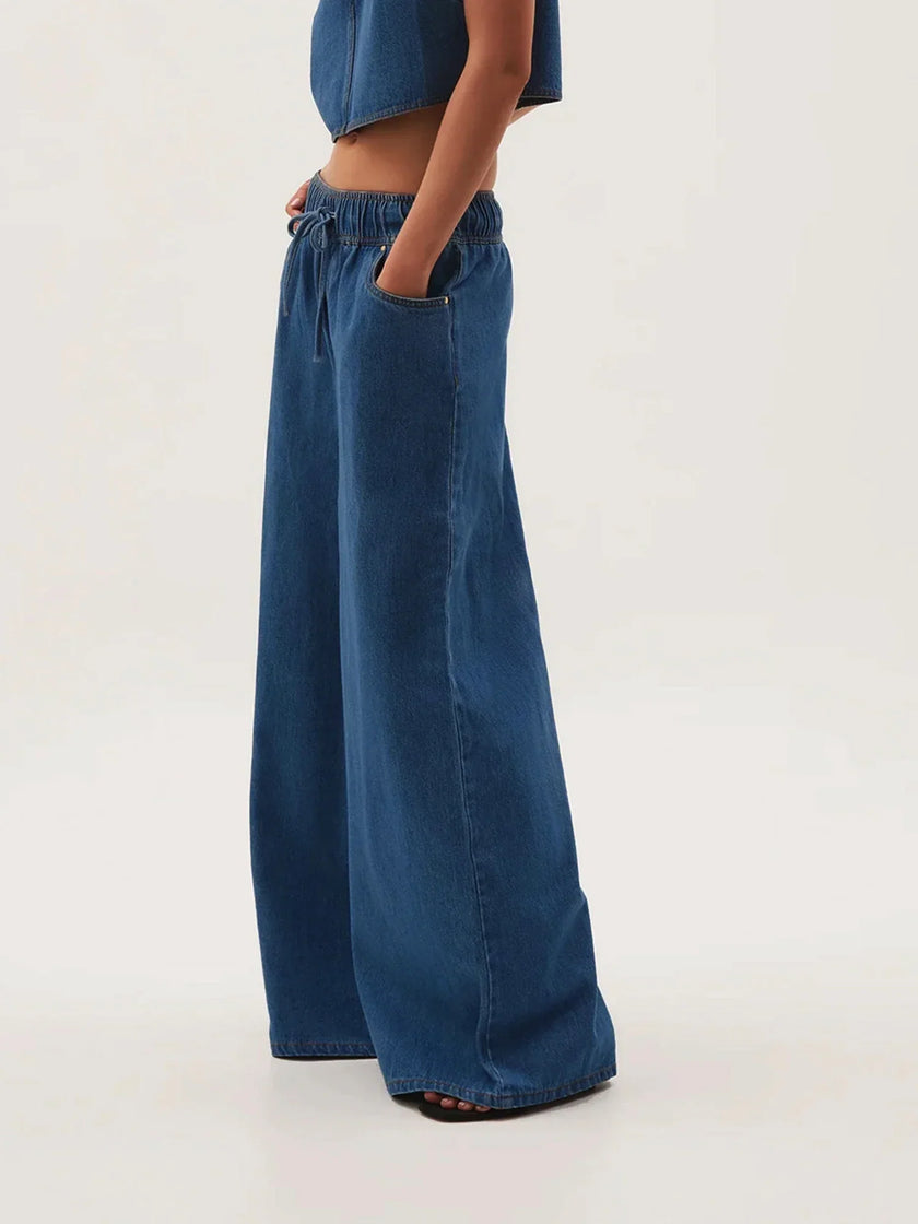 Blue denim wide-leg drawstring jeans for women by FJØRNA, relaxed fit, featuring a casual, comfortable style and adjustable waistband.