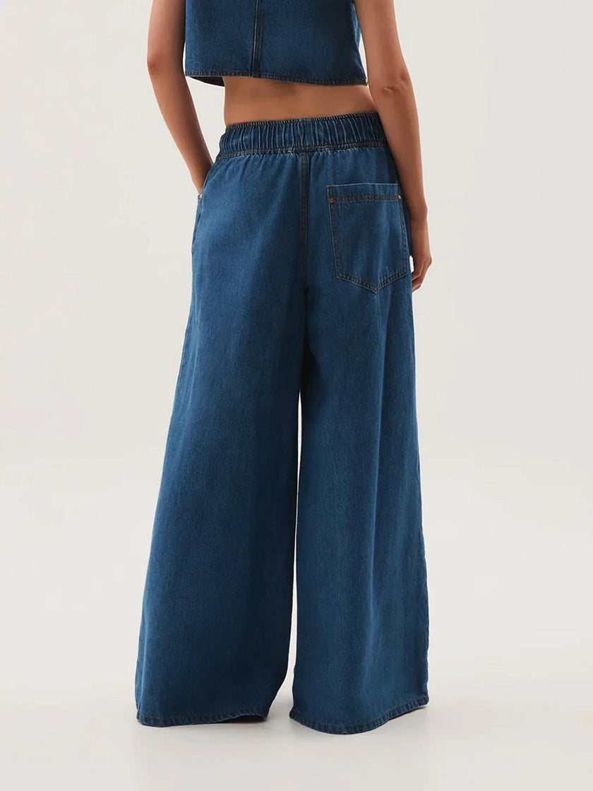 Blue denim wide-leg drawstring women's jeans by FJØRNA, relaxed fit pants with a casual, comfortable style.