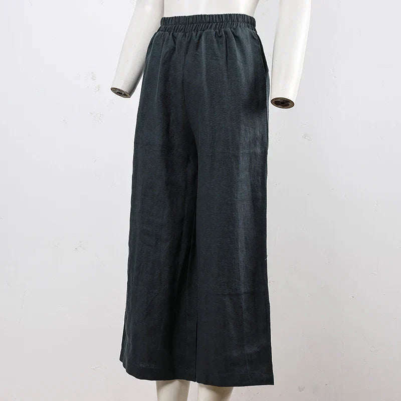 FJØRNA women's linen wide-leg trousers with drawstring, pull-on style, featuring a relaxed fit and lightweight fabric.