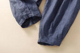 FJØRNA linen tapered trousers for women, showcasing lightweight, breathable pants with a relaxed fit and tapered leg design.