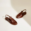 FJØRNA women's brown Italian leather woven slingback sandals with open toe and ankle strap.