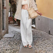FJØRNA women's knit wide-leg trousers with drawstring waist, featuring a relaxed fit and soft, textured fabric.