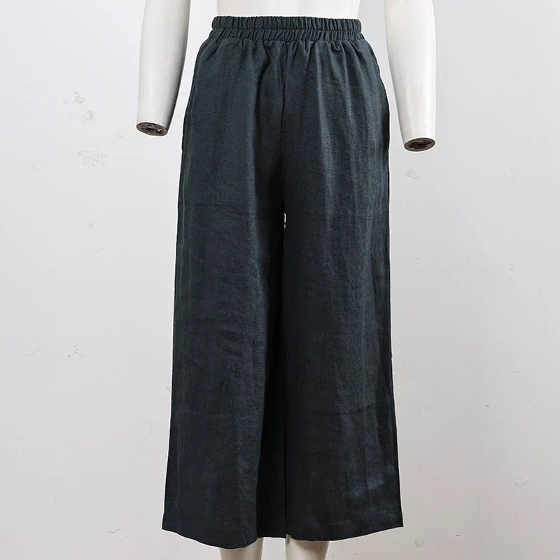 FJØRNA women's linen wide-leg trousers with drawstring pull-on design, relaxed fit, and lightweight fabric.
