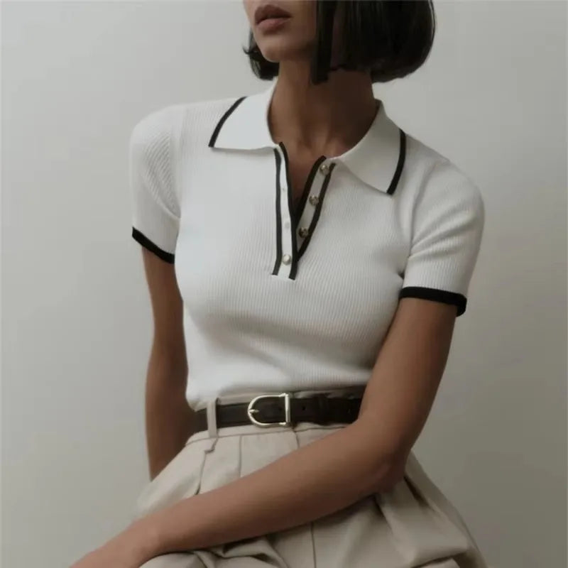 Black FJØRNA cotton polo top for women, women's short-sleeve polo shirt with classic collar and button closure.