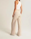 White wide-leg high-waist trousers for women by FJØRNA, featuring a relaxed fit and elegant high-rise design.