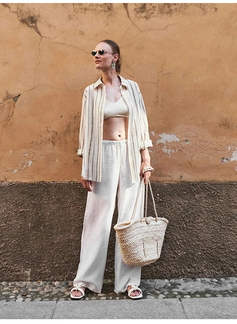 FJØRNA knit wide-leg women's trousers with drawstring waist, featuring a relaxed fit and soft, textured fabric.