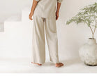 FJØRNA linen wide-leg trousers for women, loose pull-on pants with a relaxed fit, shown in a natural fabric and comfortable style.
