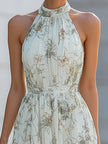 FJØRNA Fiona Flowy Halter Maxi Dress in white, sleeveless with a flowing fabric and halter neckline, perfect for summer events.