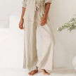FJØRNA linen wide-leg pants for women, loose pull-on trousers with relaxed fit and natural fabric, shown on a model.