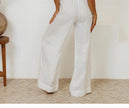 FJØRNA linen wide-leg pull-on trousers for women, loose fit, lightweight and comfortable, shown in natural beige color.