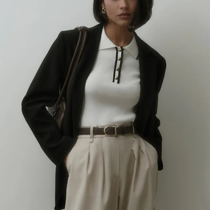Black cotton polo top for women by FJØRNA, stylish and comfortable women's polo shirt with classic collar and short sleeves.