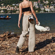 FJØRNA women's knit wide-leg trousers with drawstring waist, showcasing soft fabric and relaxed fit in natural light.