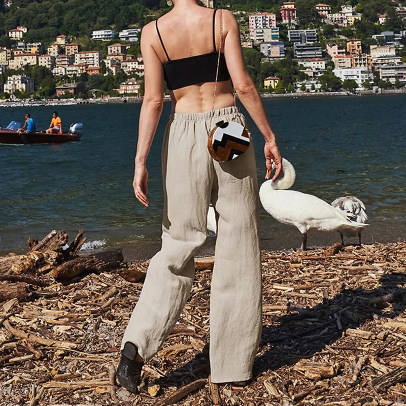 FJØRNA women's knit wide-leg trousers with drawstring waist, showcasing soft fabric and relaxed fit in natural light.