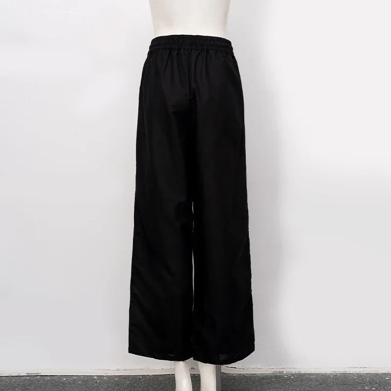 FJØRNA cotton linen wide-leg women's trousers with drawstring pull-on design, showcasing relaxed fit and casual style.