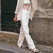 FJØRNA women's knit wide-leg trousers with drawstring waist, soft fabric, and relaxed fit, shown in a neutral color.