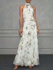 FJØRNA Jasmine floral halter wedding guest dress with elegant design and vibrant floral pattern, perfect for special occasions.