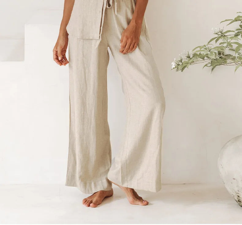FJØRNA linen wide-leg trousers for women, loose pull-on pants with a relaxed fit and flowy silhouette, shown on a model.