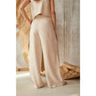FJØRNA women's knit wide-leg trousers with elastic waistband, showcasing a relaxed fit and soft, textured fabric.