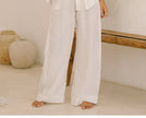 FJØRNA linen wide-leg trousers for women, loose pull-on pants with a relaxed fit and natural fabric appearance.