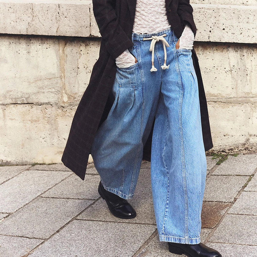 Women’s wide-leg cotton jeans with drawstring waist by FJØRNA, featuring relaxed fit and casual style.