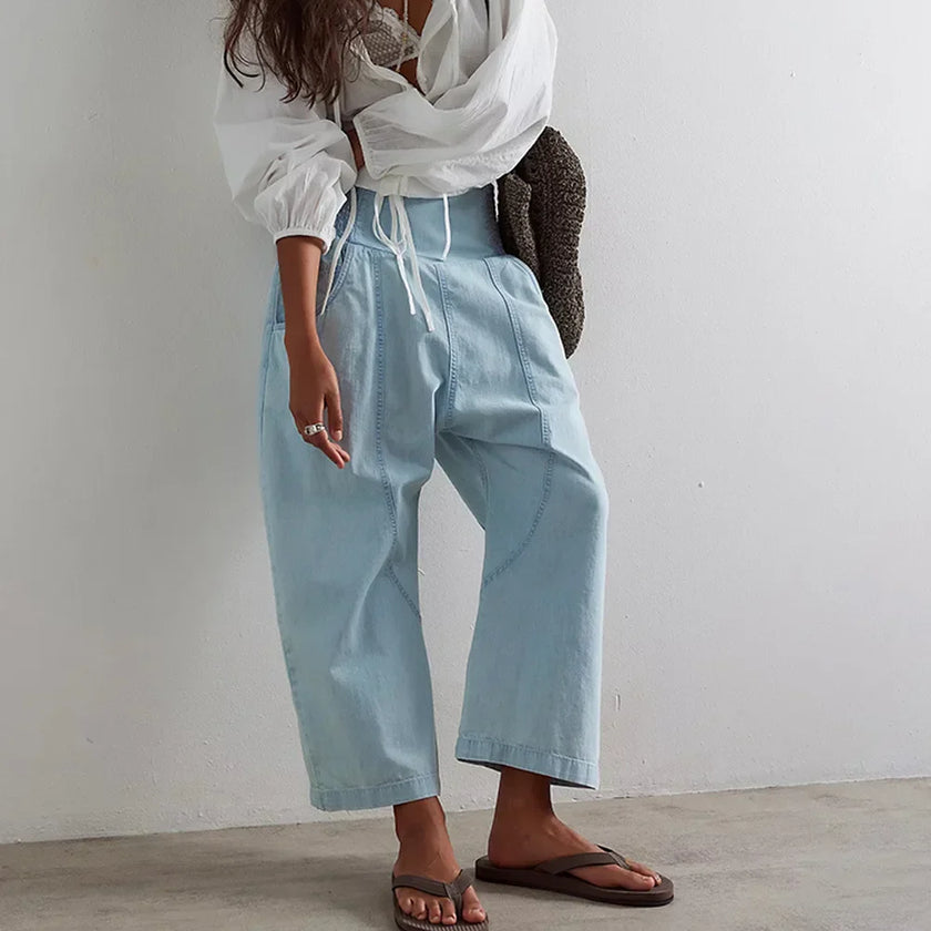 FJØRNA women's wide-leg denim jeans showing a high-waisted fit, relaxed silhouette, and classic blue denim fabric.