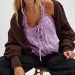 FJØRNA women's lace cami top with front tie, featuring delicate lace fabric and a stylish, feminine design.