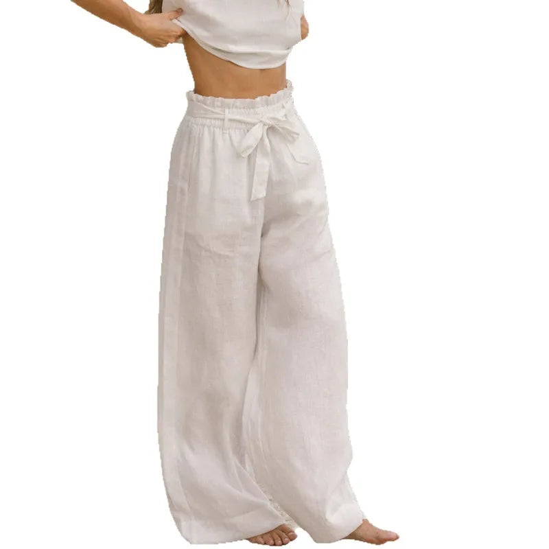 FJØRNA linen wide-leg trousers for women, loose pull-on pants with relaxed fit and lightweight fabric, shown on a model.