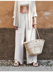 FJØRNA women's knit wide-leg trousers with drawstring waist, shown in a relaxed fit, soft fabric, and stylish design.